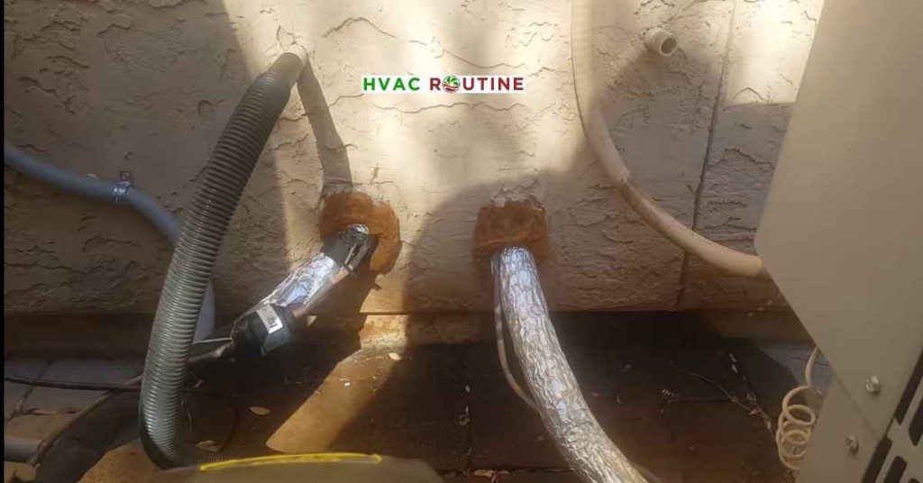 Clearing an AC condensate drain line clog using a wet dry shop vacuum