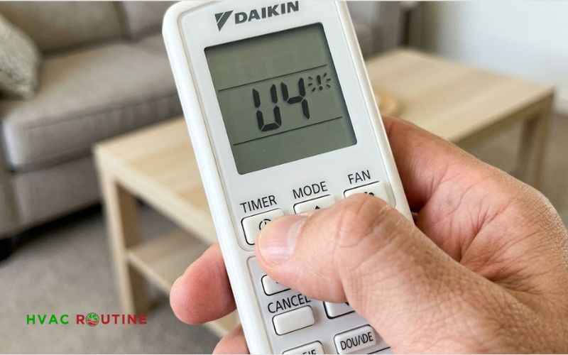 Holding the cancel button on Daikin remote control to run diagnostic fault code check