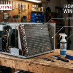 Window air conditioner disassembled on an outdoor workbench with coil cleaner spray and fin comb